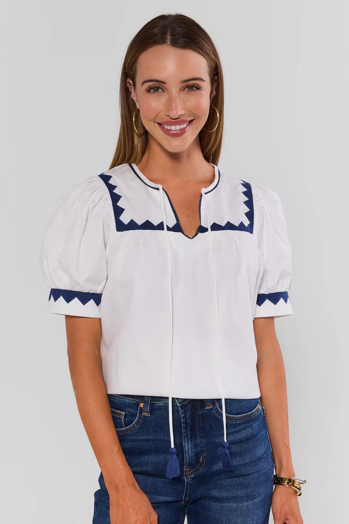 White Embroidered Trim Puff Sleeve Top with navy contrast trim, styled with dark denim, front view | Avara