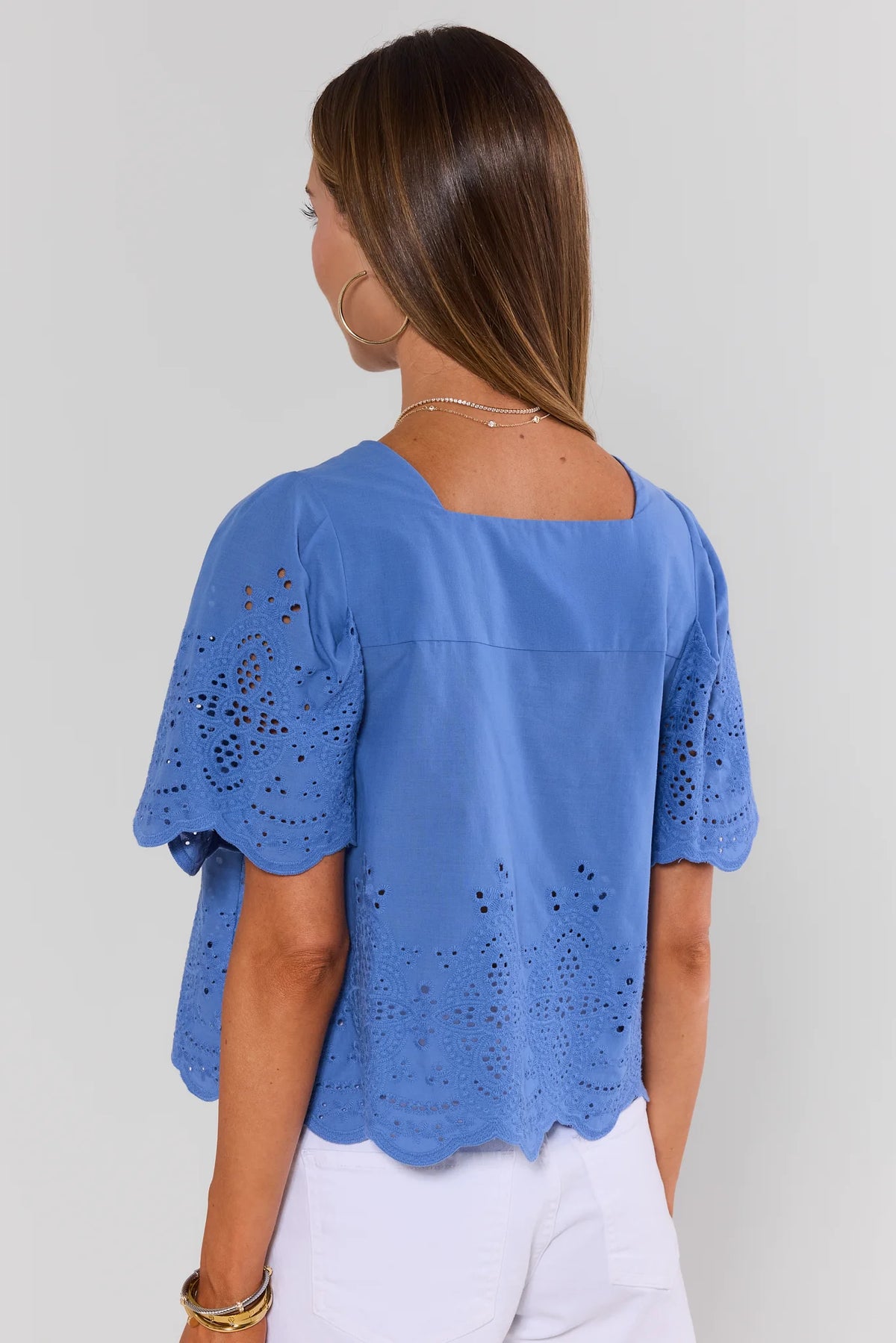 Blue eyelet top with scalloped flutter sleeves and square neck - Back View with white pants | Avara