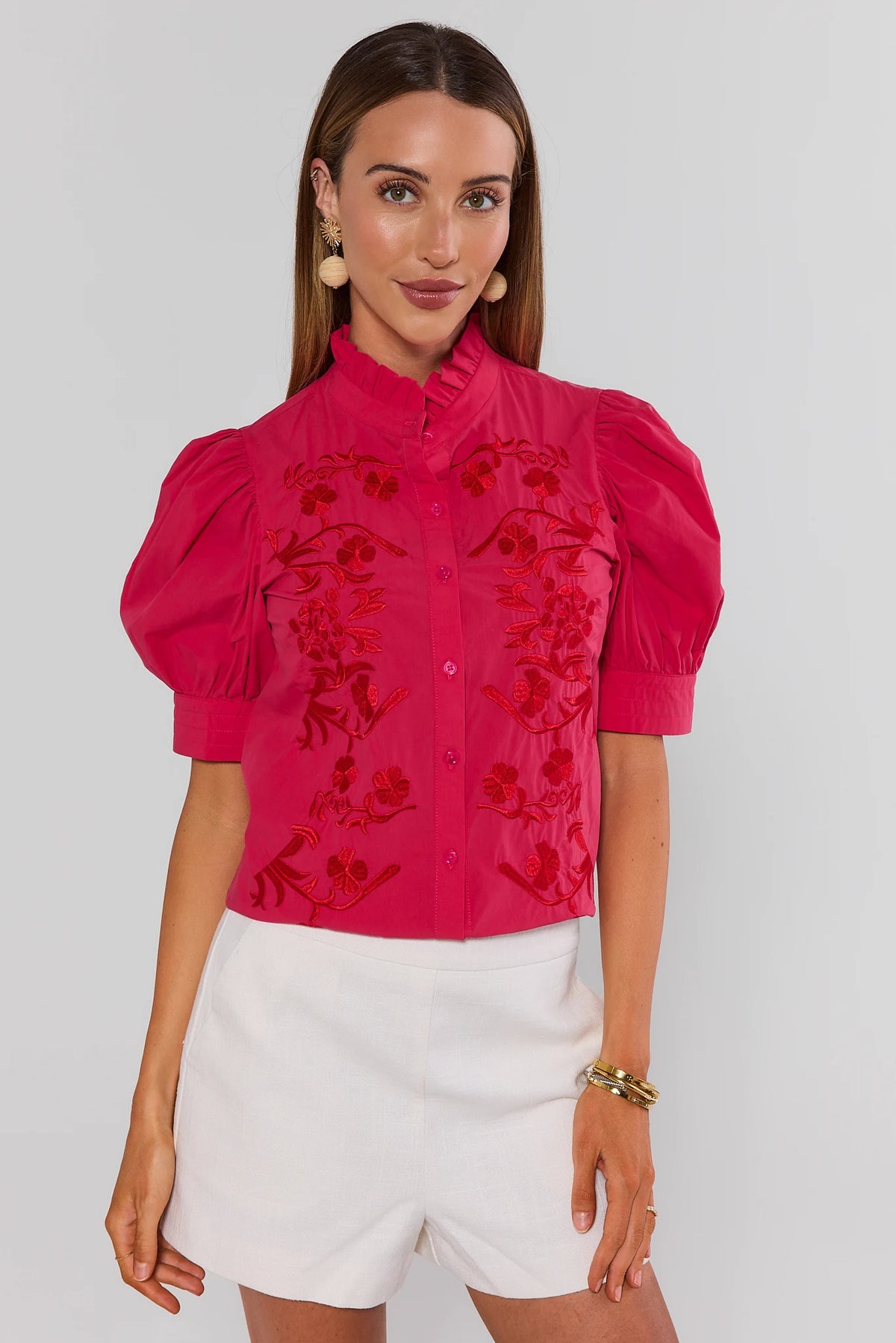 Hot pink embroidered button-up top with puff sleeves and red floral detail, styled with white shorts - Front View | Avara