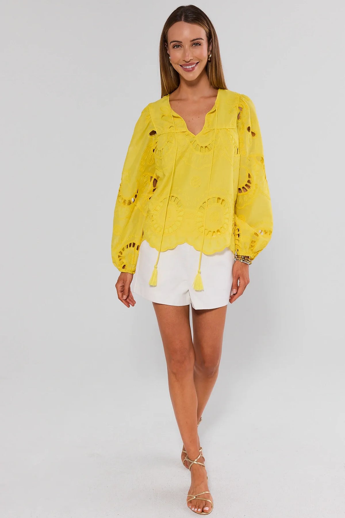 Yellow eyelet split neck top full-length front view with white shorts and gold sandals - On Model | Avara