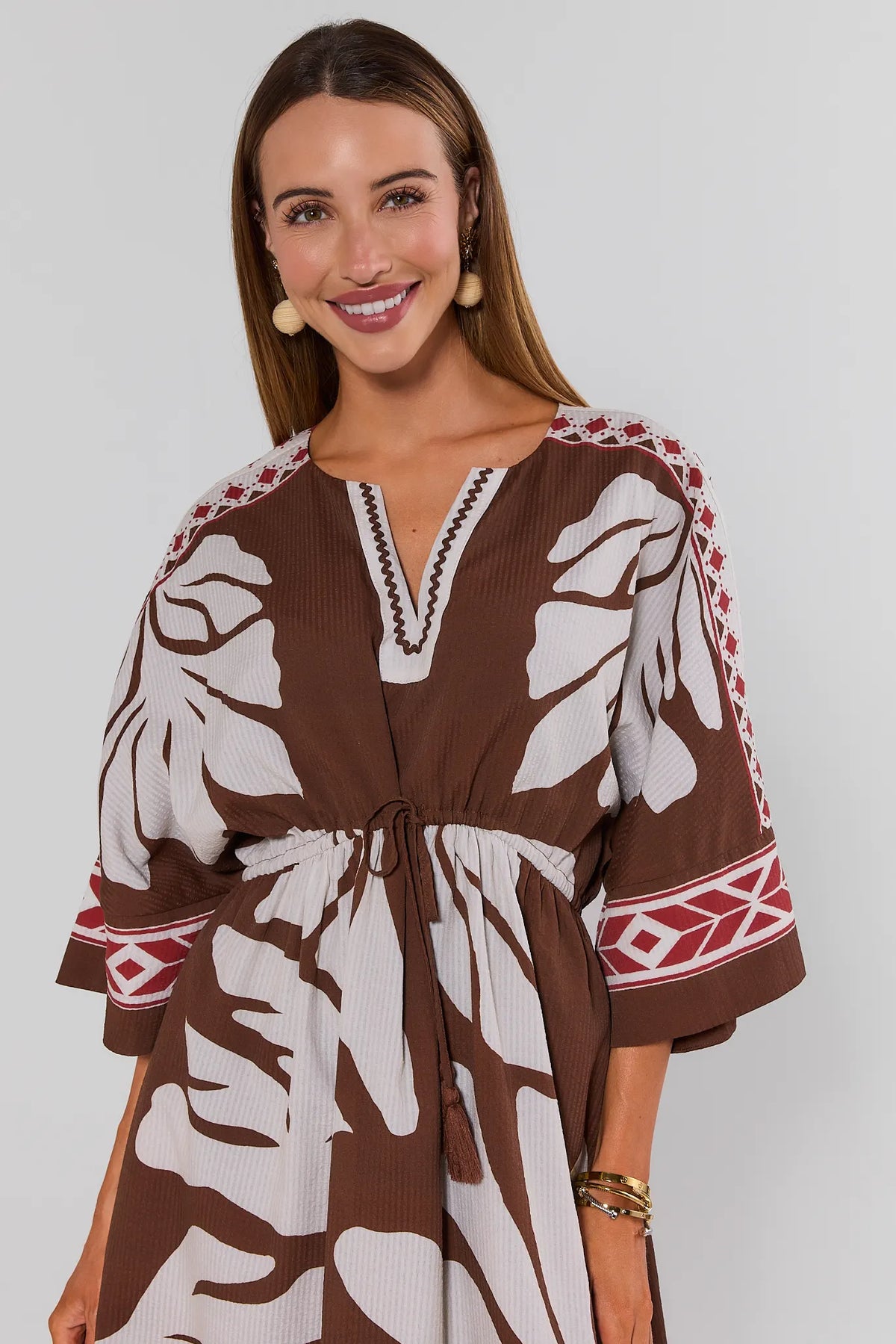 Brown Palm Print Maxi Dress V-neckline and tassel tie waist - Close-Up Detail | Avara