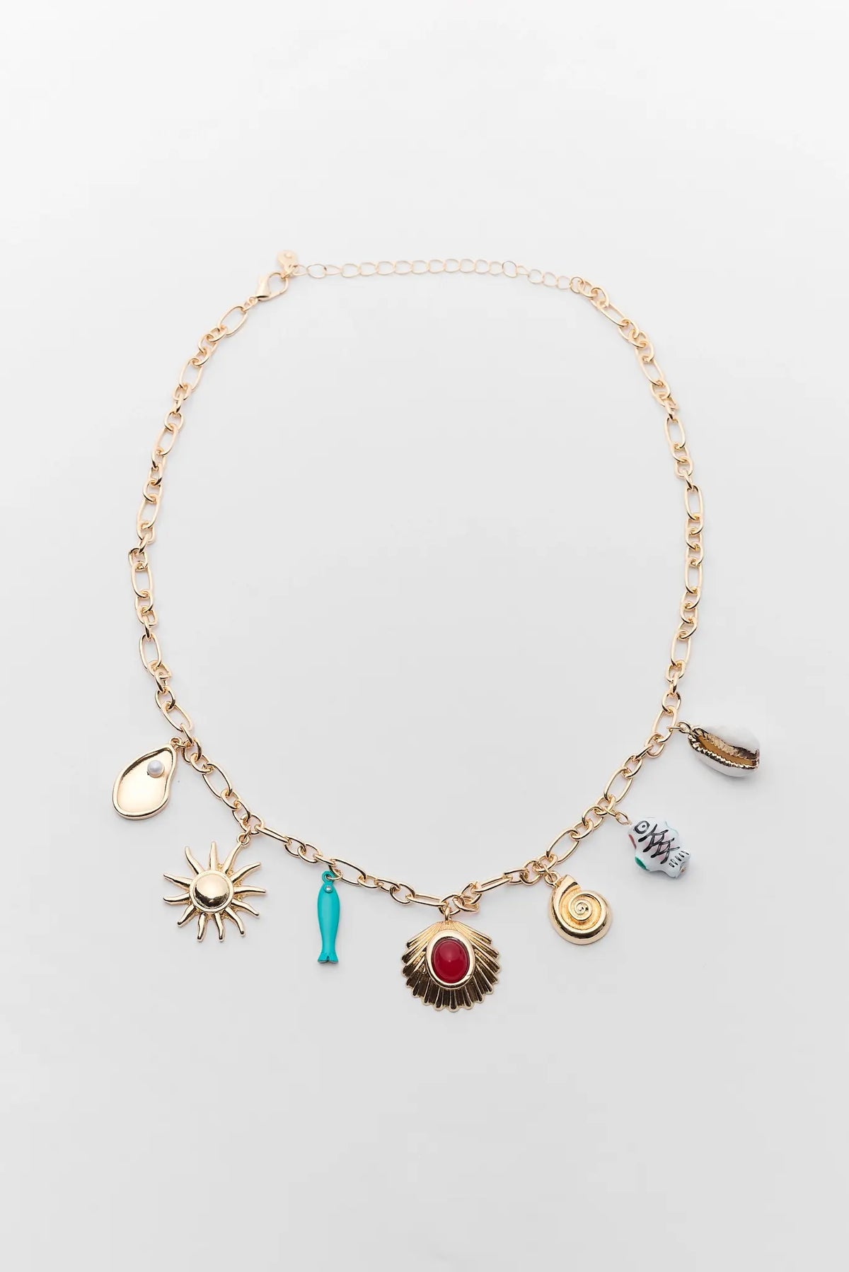 Gold Multi Charm Necklace with sun, seashell, fish & shell charms - Flat Lay | Avara
