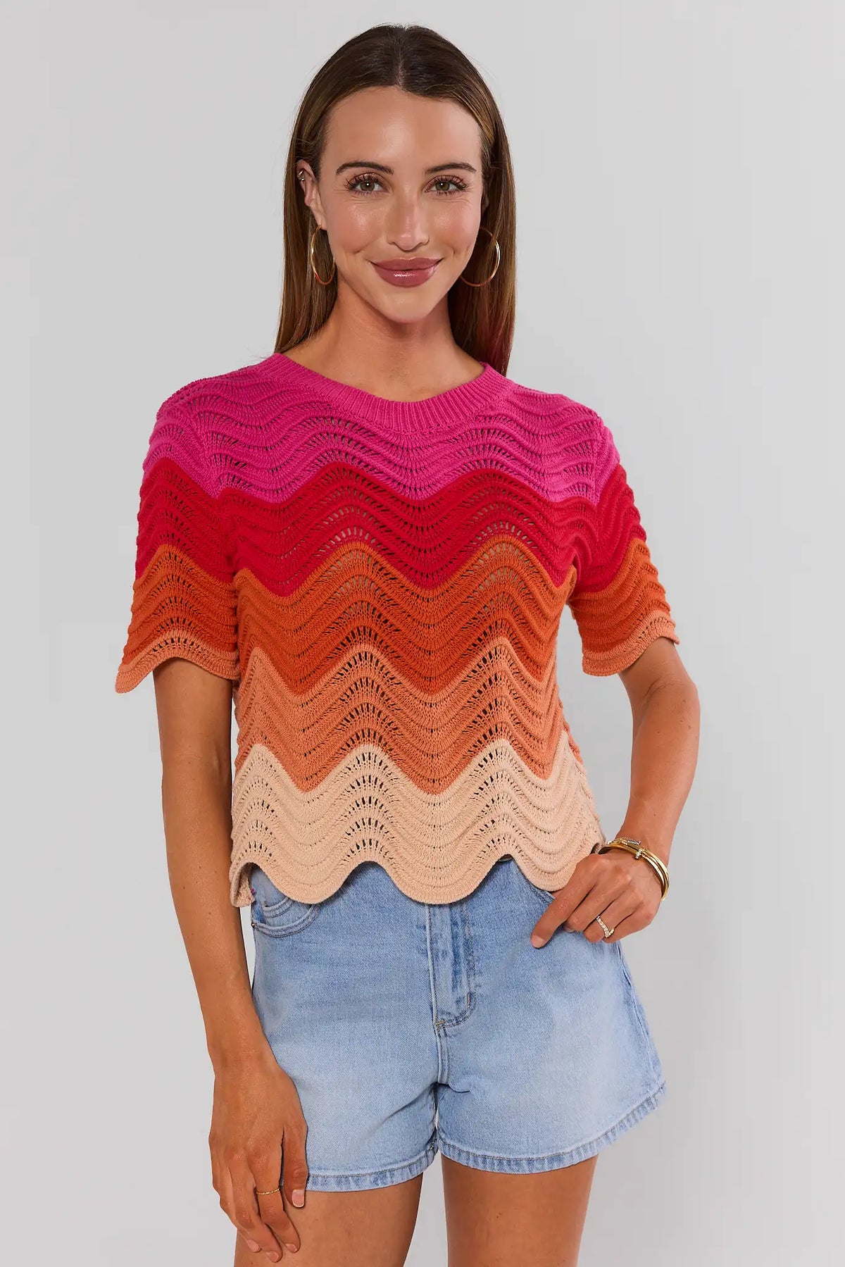 Pink Color Block Knit Top with chevron waves and scalloped hem, styled with denim shorts - Front View | Avara