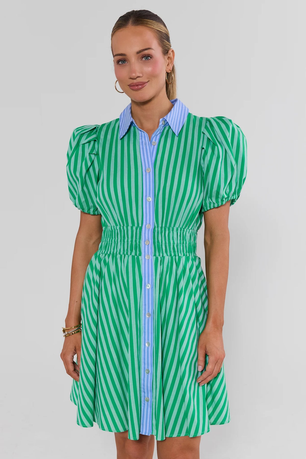 Green striped short dress with blue contrast collar, puff sleeves, smocked waist on model - Front View | Avara