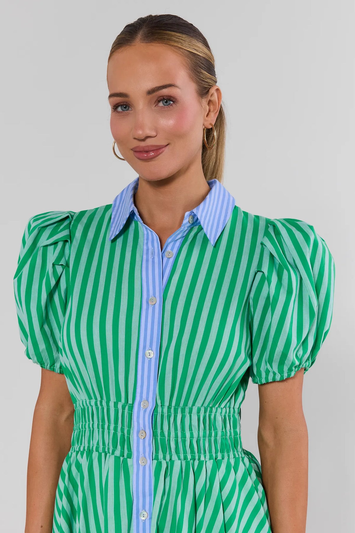 Green striped button-up dress showing puff sleeves, blue collar, and smocked waist detail - Upper Body Close-Up | Avara
