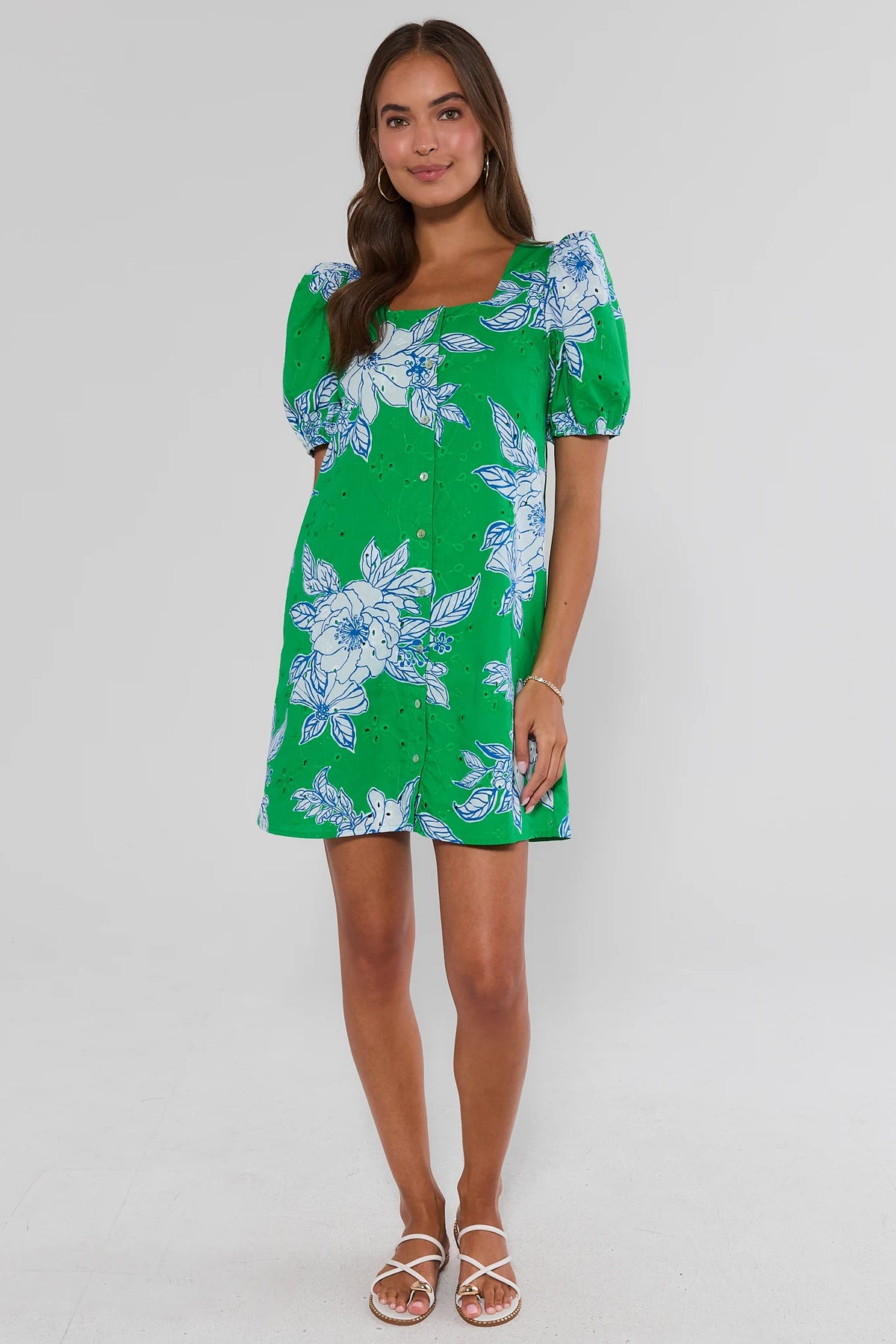 Green eyelet floral short dress styled with white sandals, full-length front view on model | Avara