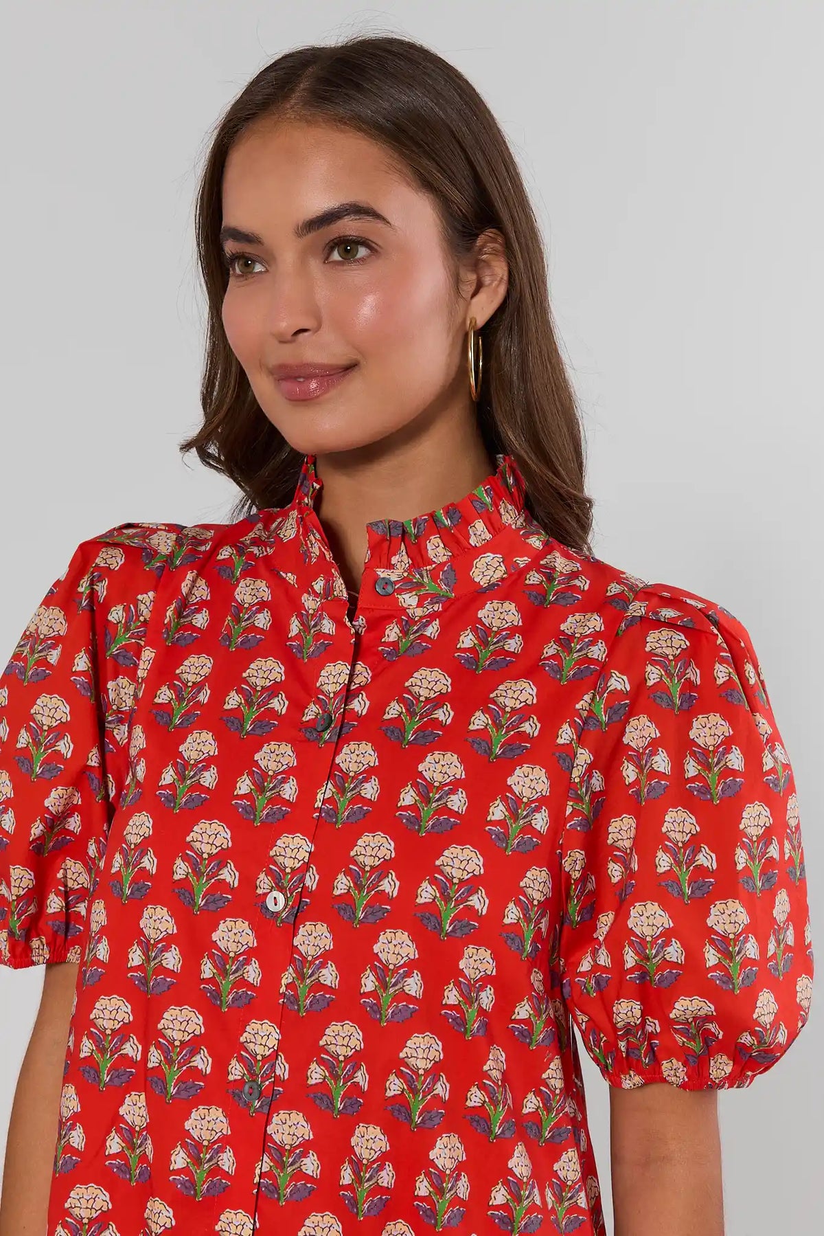 Red block print midi dress close-up detail — ruffled neckline, puff sleeves, button-front | Avara