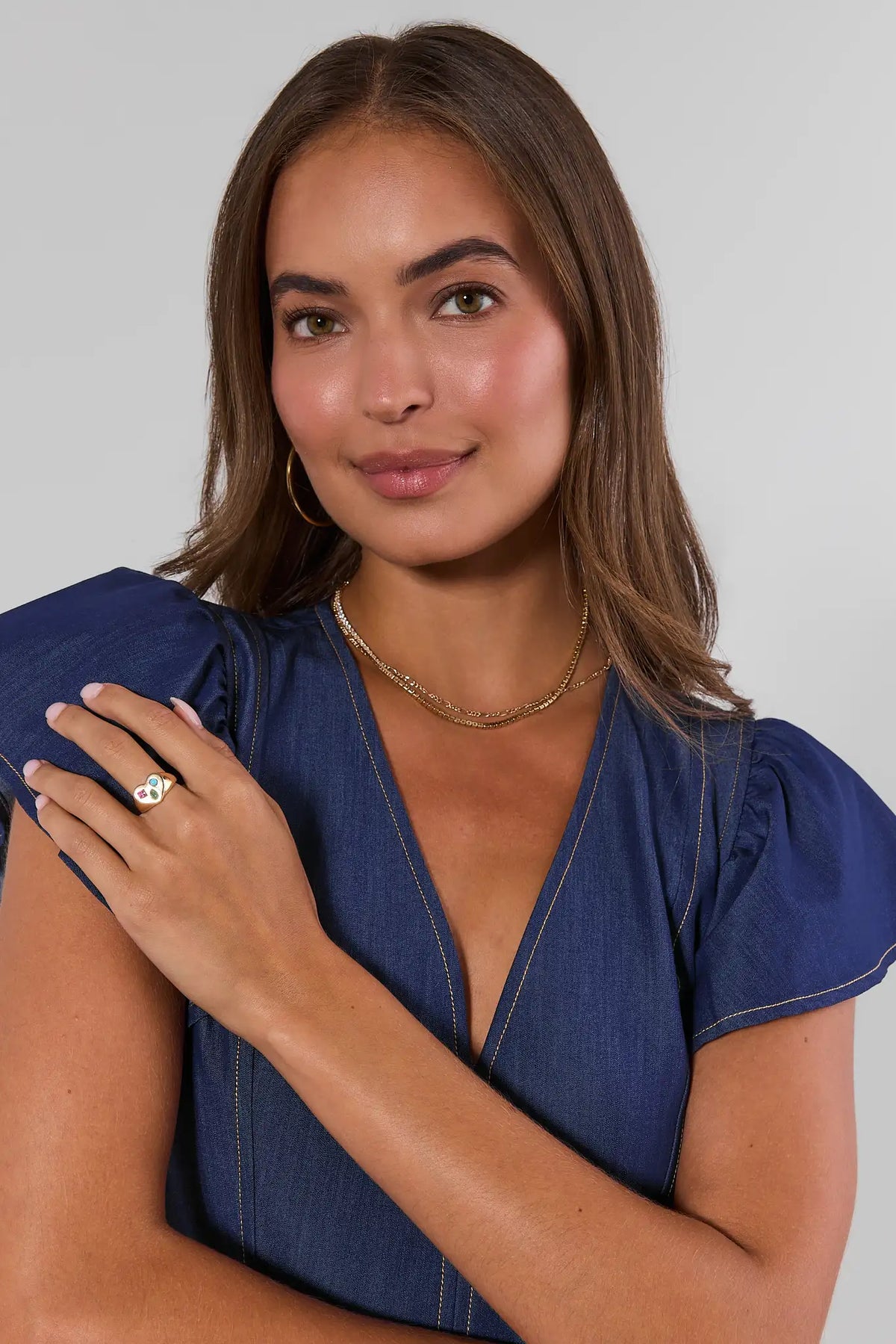Gold Heart Gem Ring styled on model in blue denim top - On Model | Avara