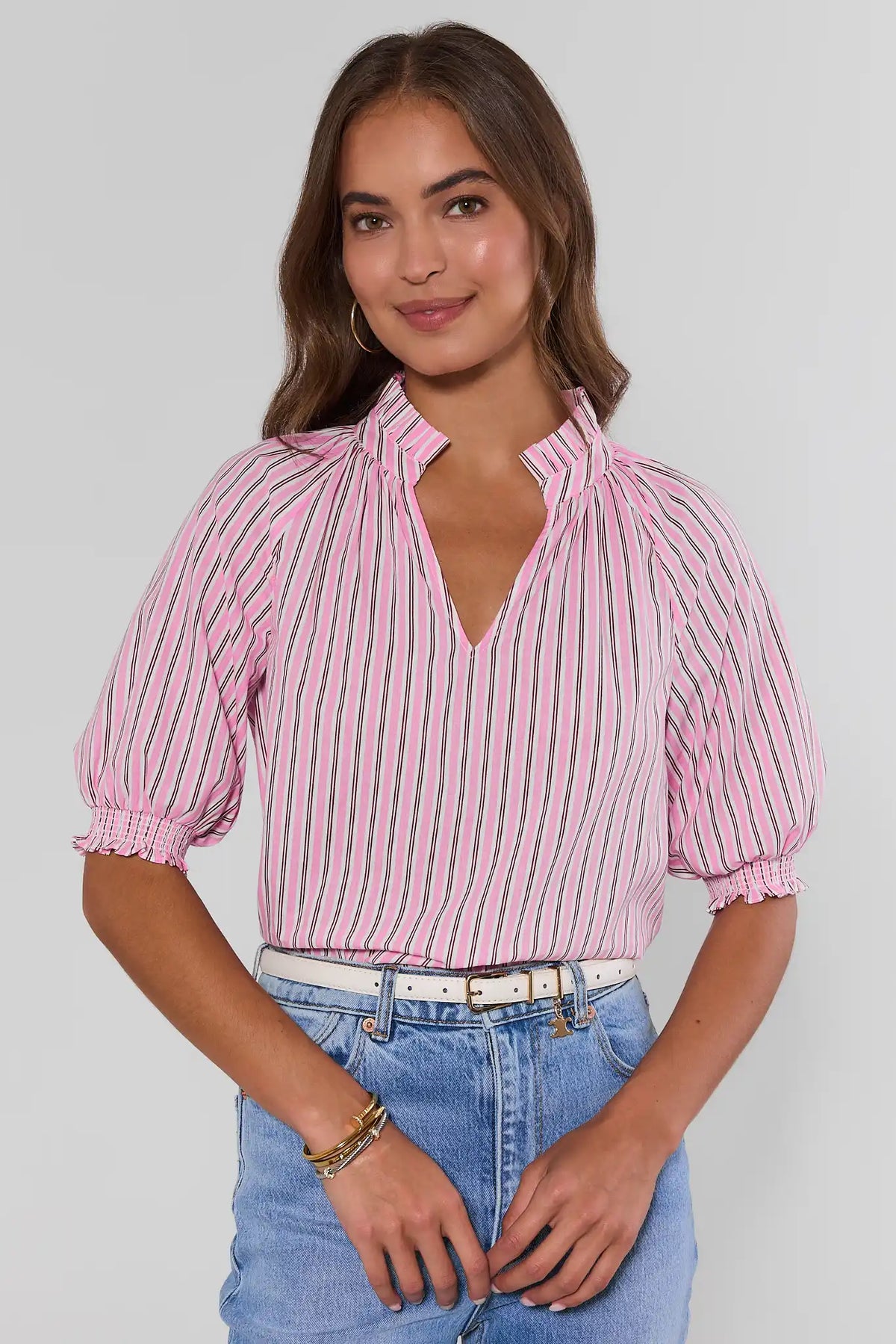 Merrick Pink Striped Split Neck Top with smocked sleeves styled with blue jeans - Front View | Avara