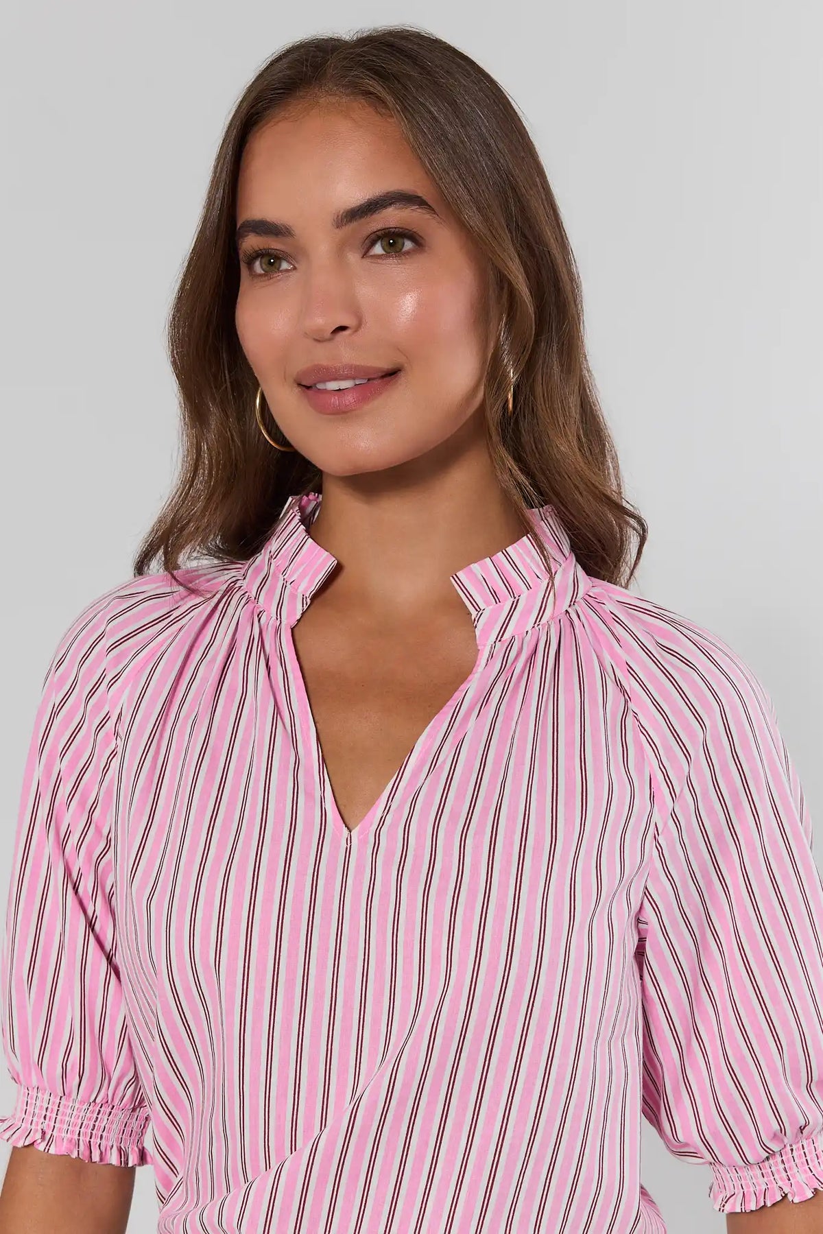 Merrick Pink Striped Split Neck Top close-up showing ruffled neckline and smocked cuff detail | Avara