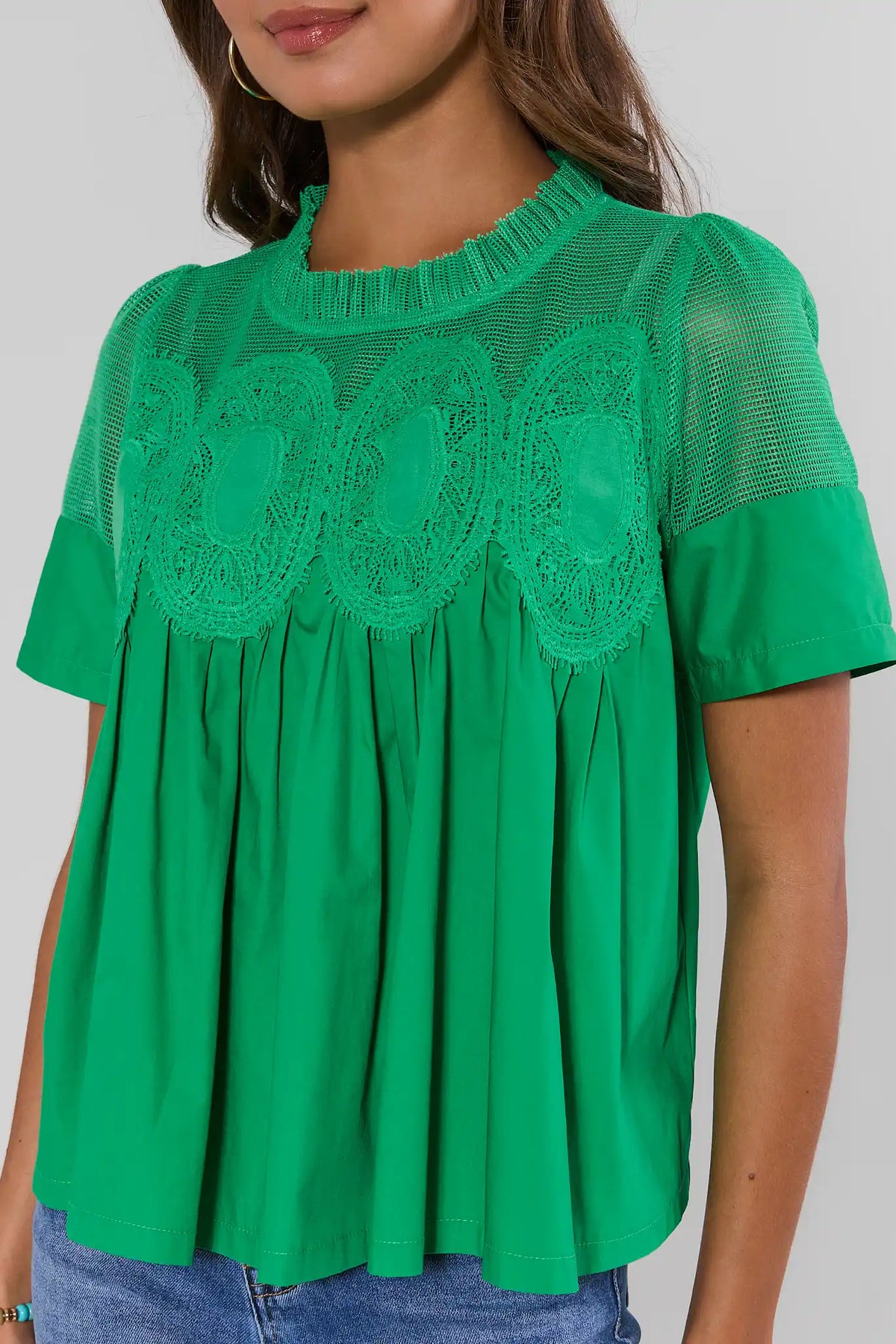 Green peplum blouse with crochet lace appliqué and mesh yoke - Close-Up Front Detail | Avara
