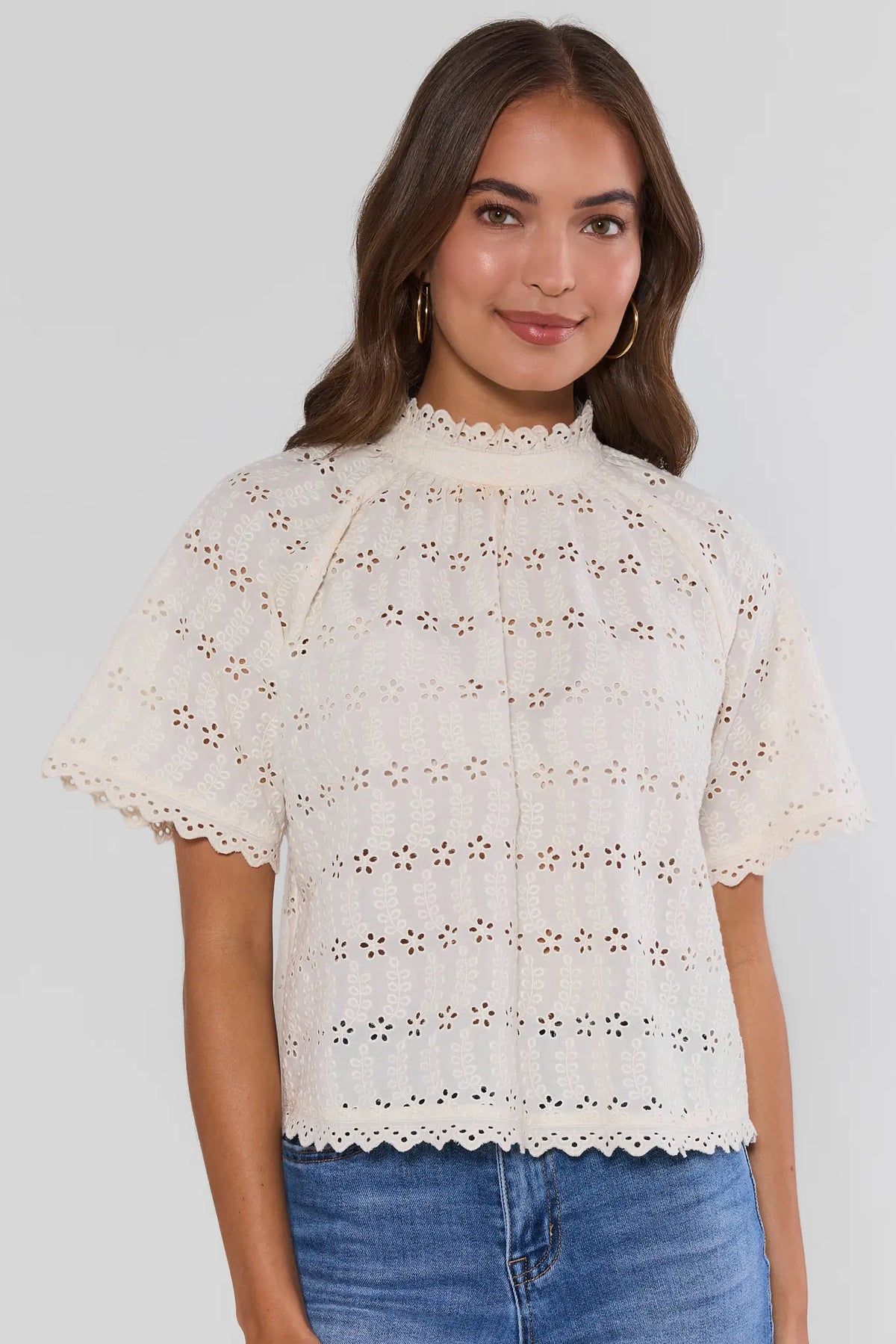 White Floral Eyelet Top - Front View, modest mock neck with flutter sleeves and scalloped hem | Avara