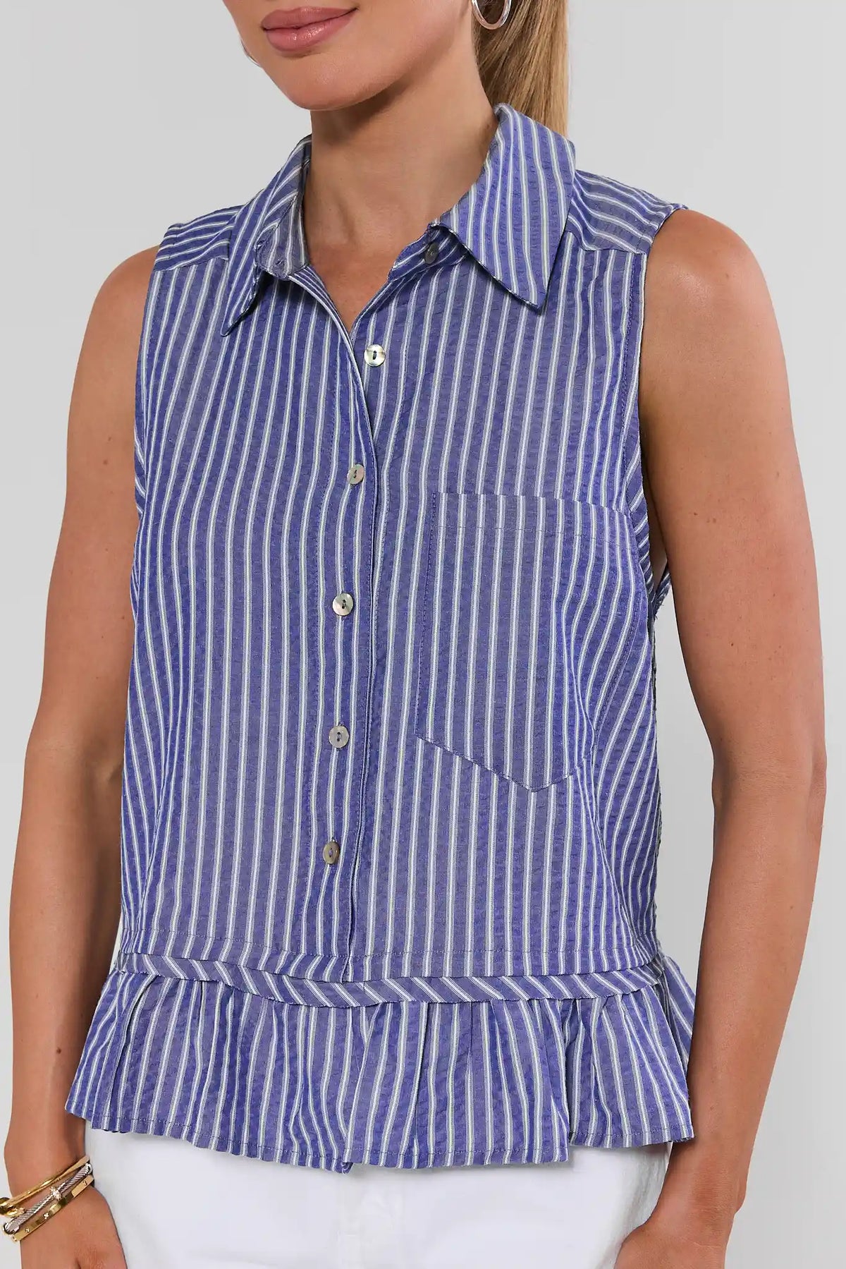 Blue striped sleeveless button-up top with ruffle hem - Close-Up Detail | Avara