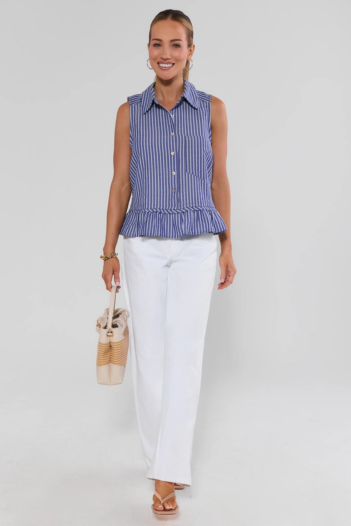 Blue striped ruffle tank top styled with white wide-leg pants and straw bag - Full Styled Look | Avara