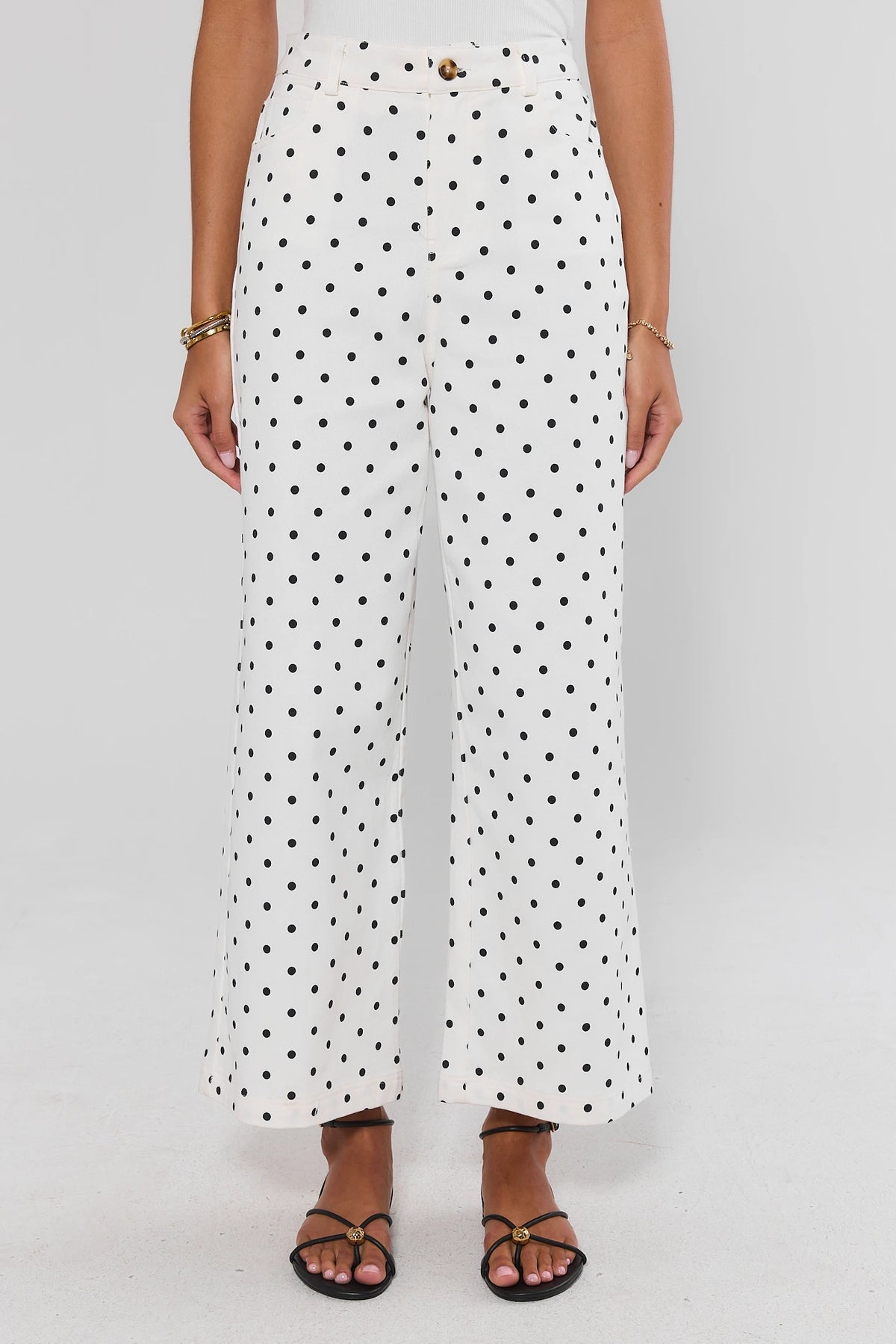 White jeans with black polka dots, high-rise wide leg silhouette, tortoise button - Front View On Model | Avara