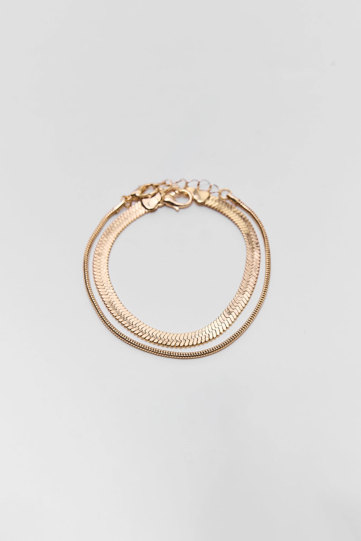 Gold Herringbone Bracelet Set - Flat Lay, Two Stacking Chain Bracelets | Avara