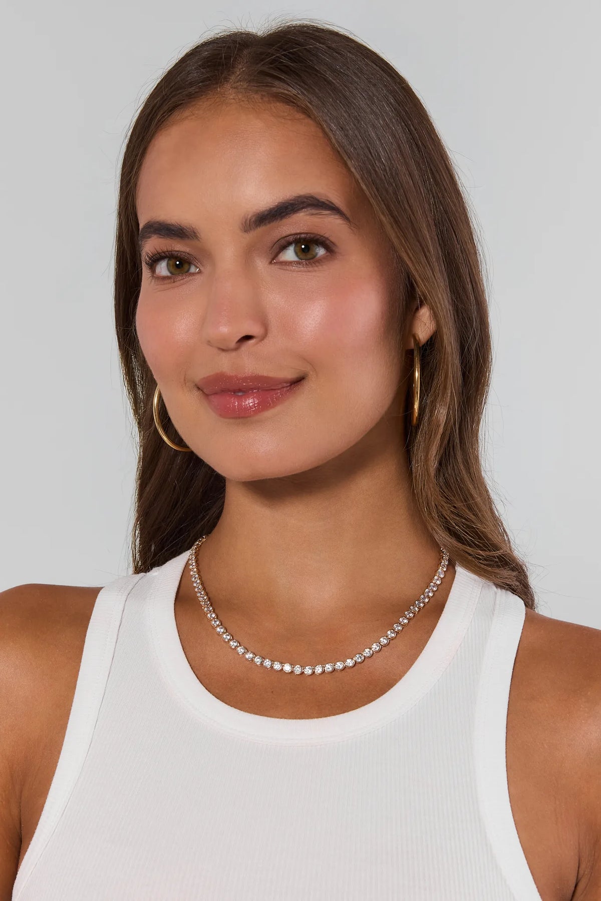 Woman wearing Gold Round Bezel Tennis Necklace with white tank top - On Model | Avara