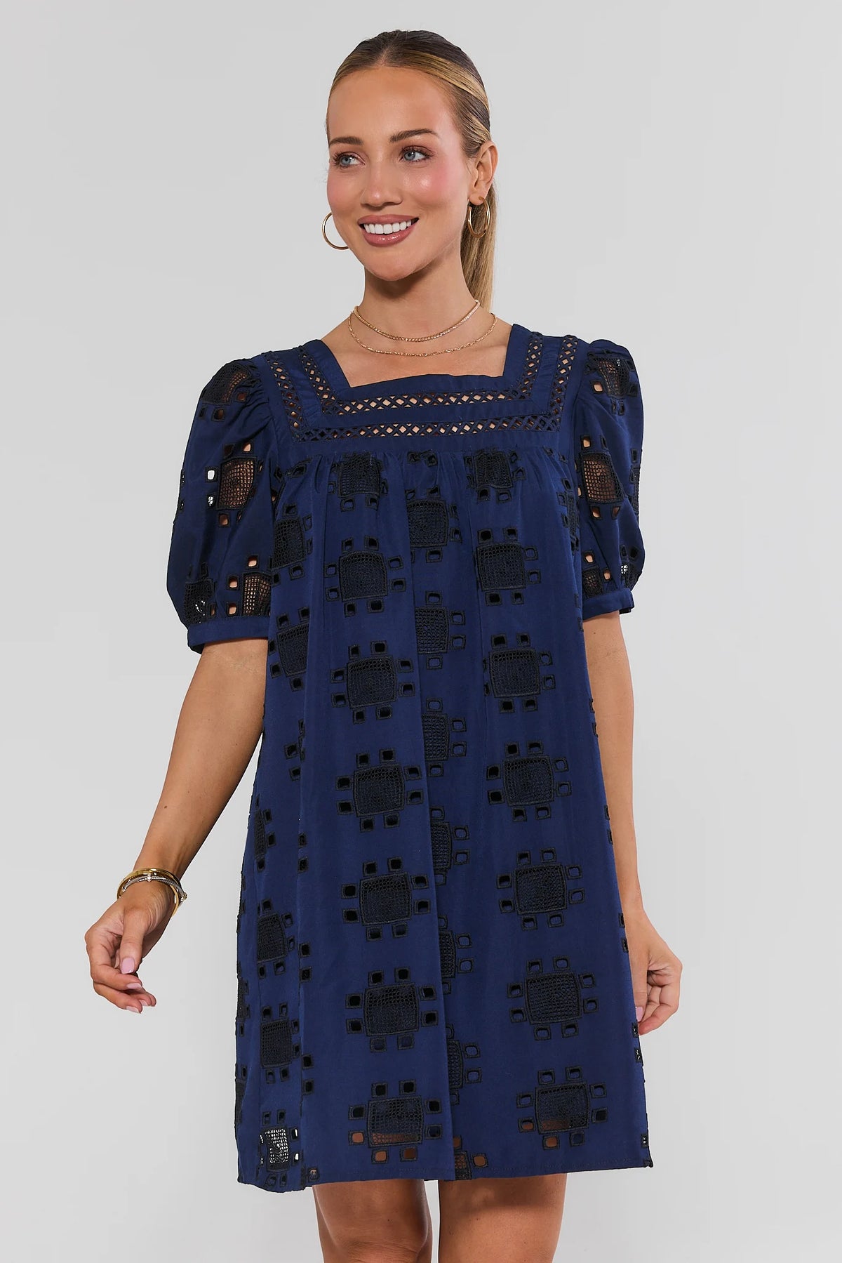 Navy Eyelet Square Neck Short Dress with puff sleeves, front view on model | Avara