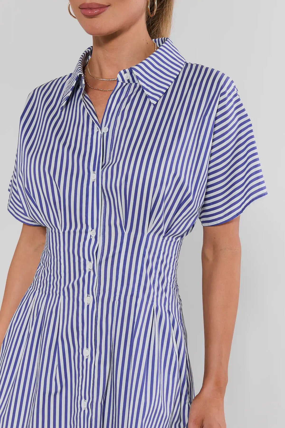 Blue white striped button-up short dress close-up showing collar and button detail on model | Avara