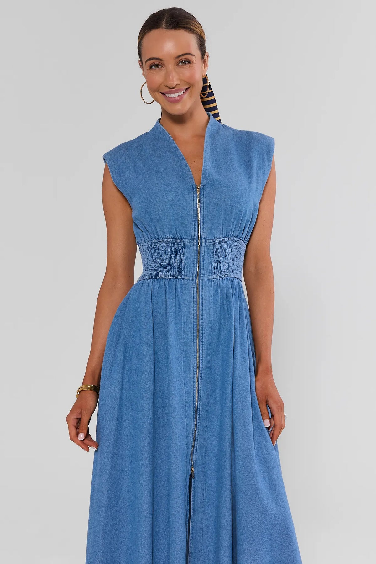 Medium wash denim Collins Zip Up Midi Dress - smocked waist and V-neckline close-up, front view | Avara