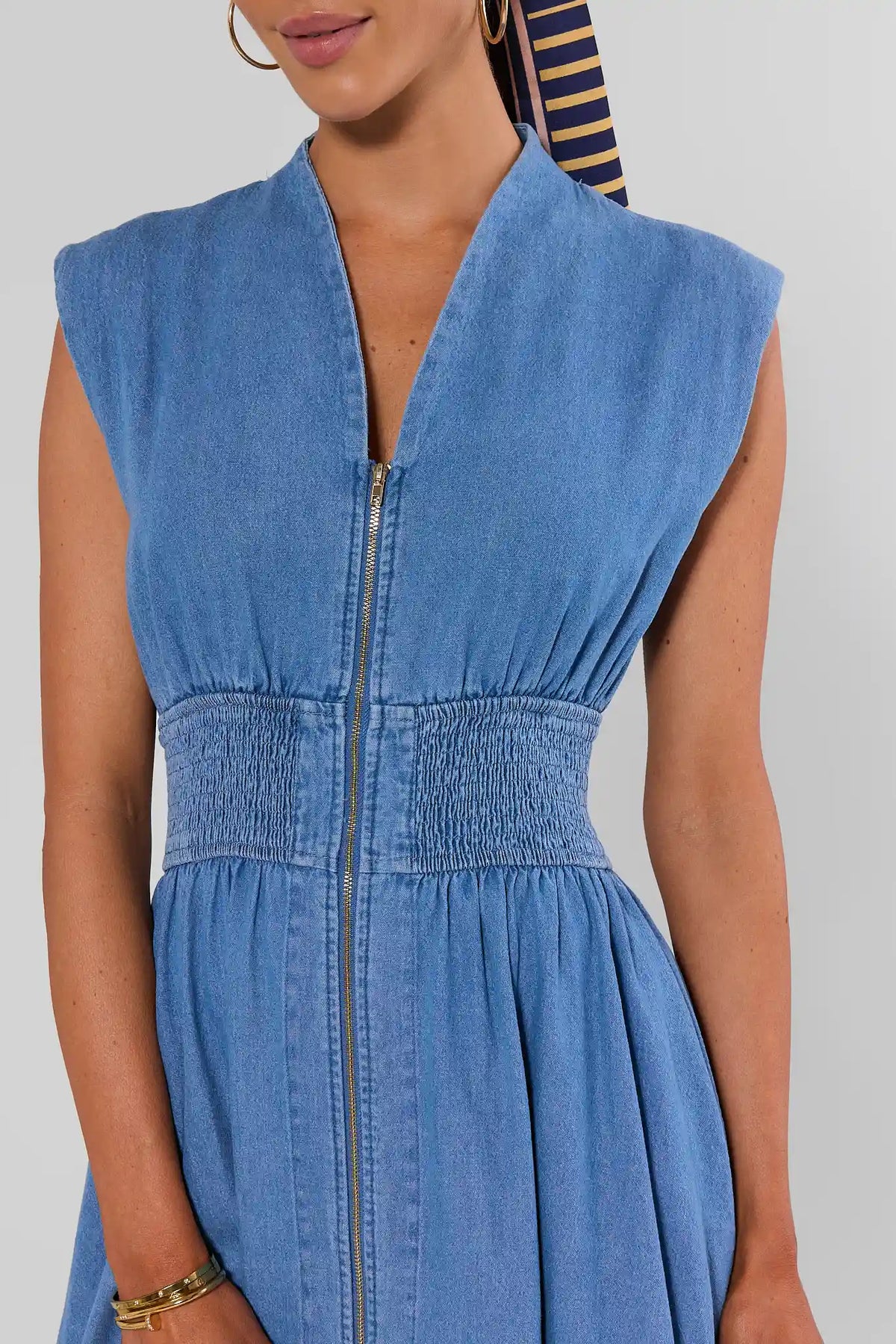 Collins Medium Wash Zip Up Midi Dress - close-up of gold zip front and smocked waist detail | Avara