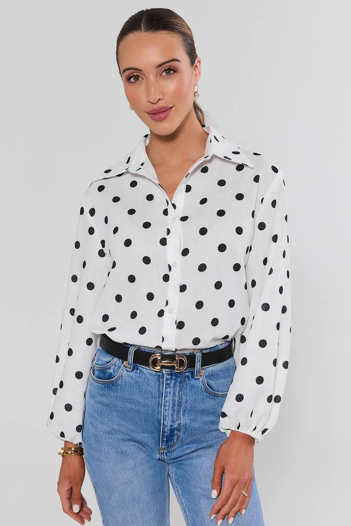 Cassidy White Polka Dot Button-Up Top with long sleeves styled with jeans - Front View | Avara