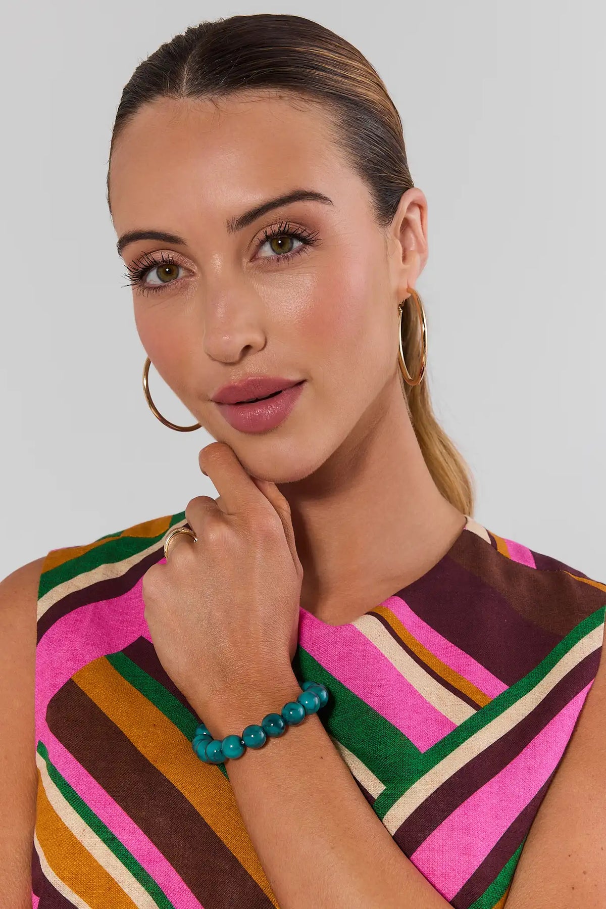 Woman wearing Teal Beaded Stretch Bracelet with colorful striped top - On Model | Avara