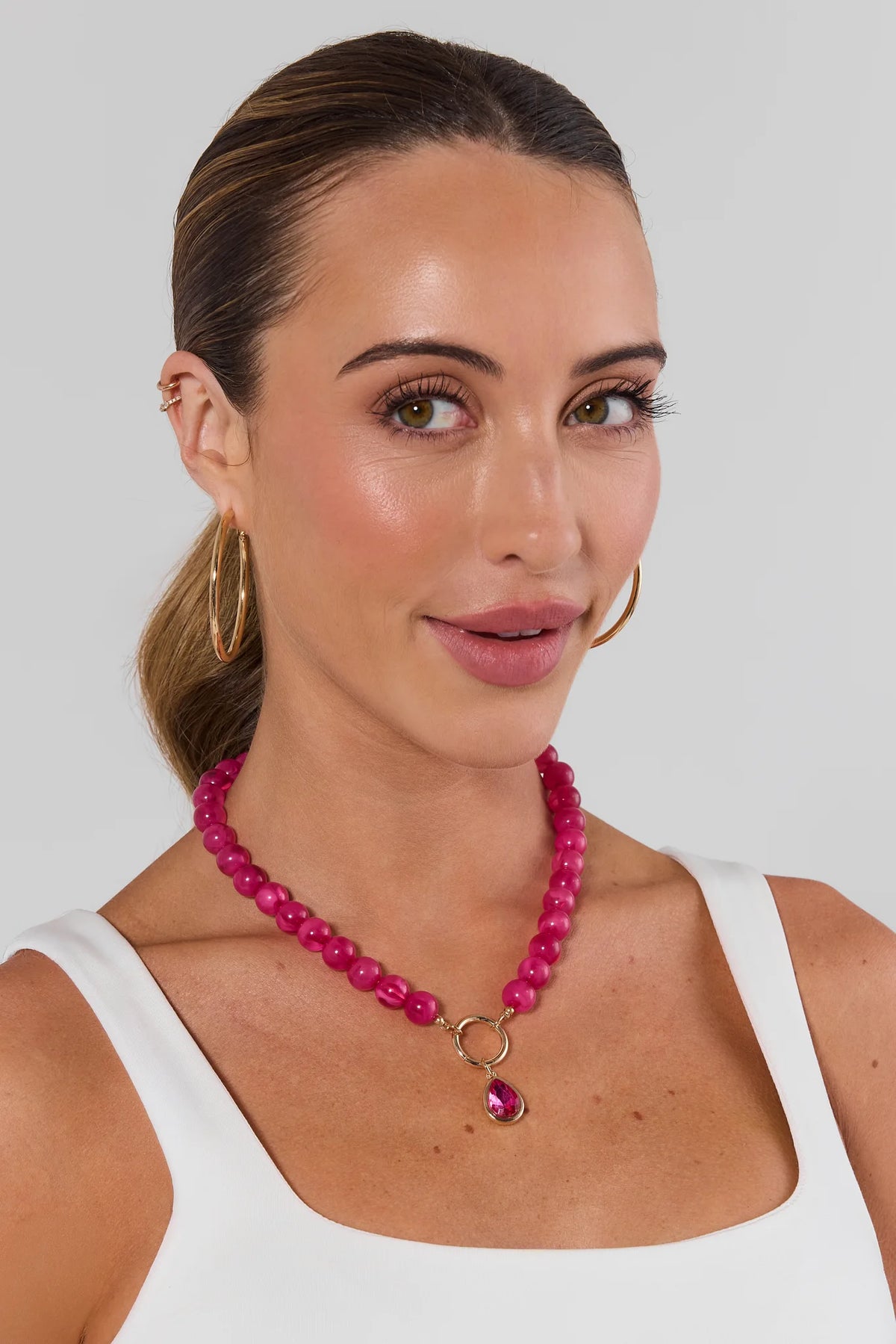 Woman wearing Pink Rhinestone Drop Necklace with gold hoops - On Model | Avara