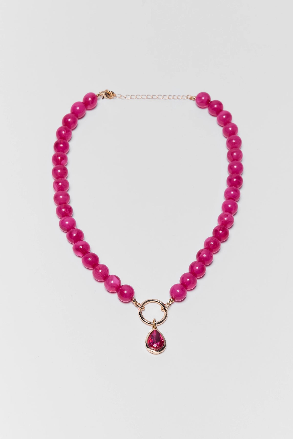 Pink Beaded Stone Drop Necklace with Gold Ring Pendant - Flat Lay | Avara