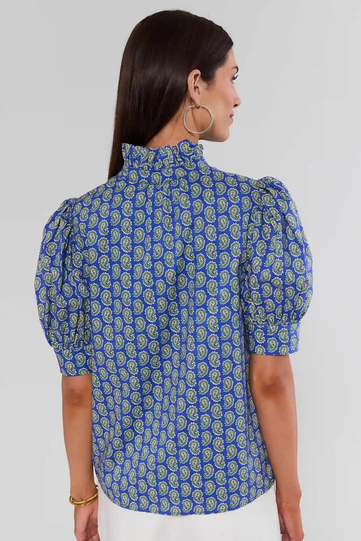 Back view of Gracie Blue Paisley Print Top showing ruffle high neck and puff sleeves on model | Avara