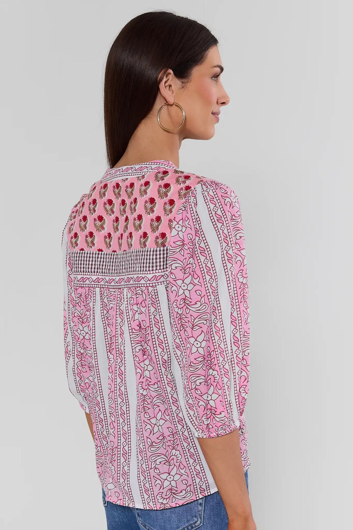 Back view of pink mixed-print THML top with floral yoke, gingham band, and 3/4 sleeves paired with blue jeans | Avara