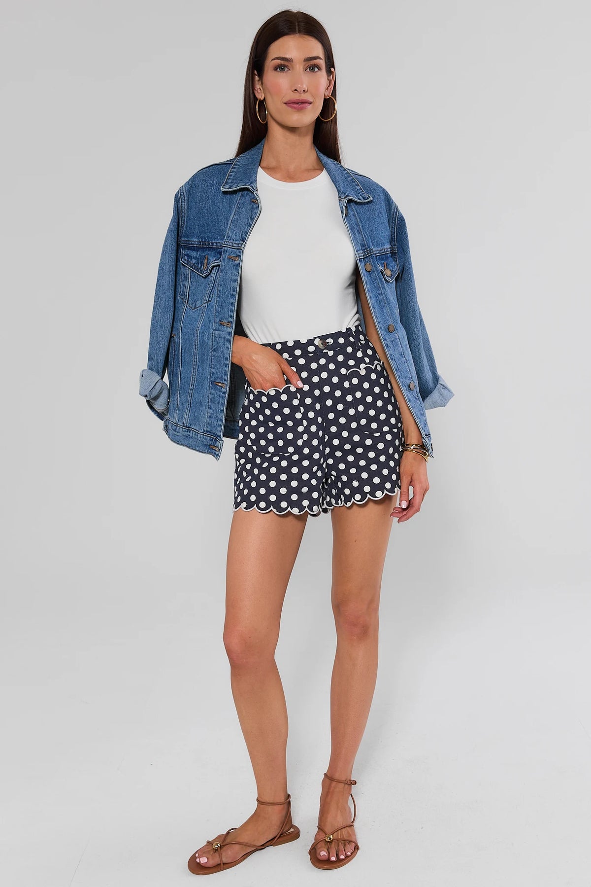 Navy polka dot scalloped shorts styled with white tee and denim jacket, full outfit view on model | Avara