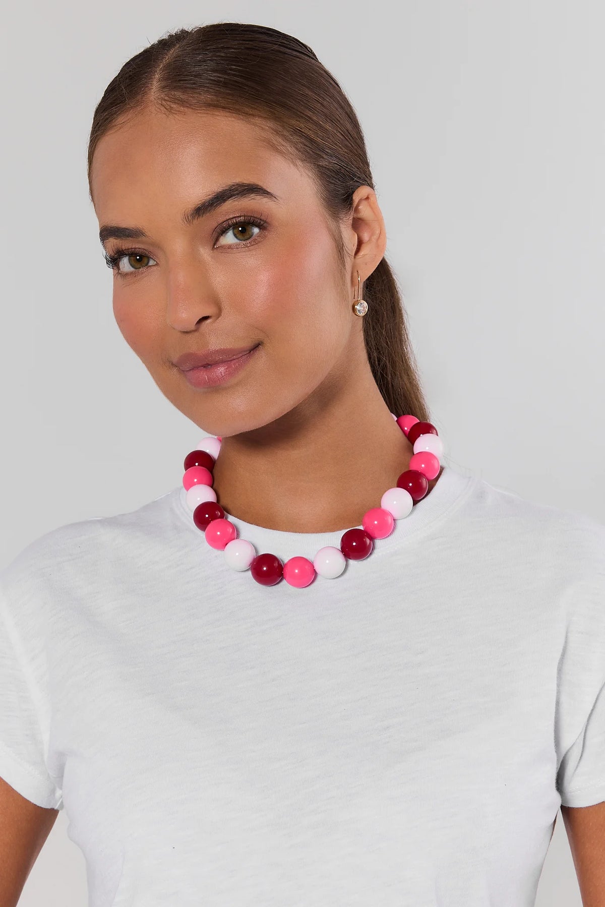Woman wearing pink chunky beaded necklace with mixed magenta and pale pink round beads over a white tee - On Model | Avara