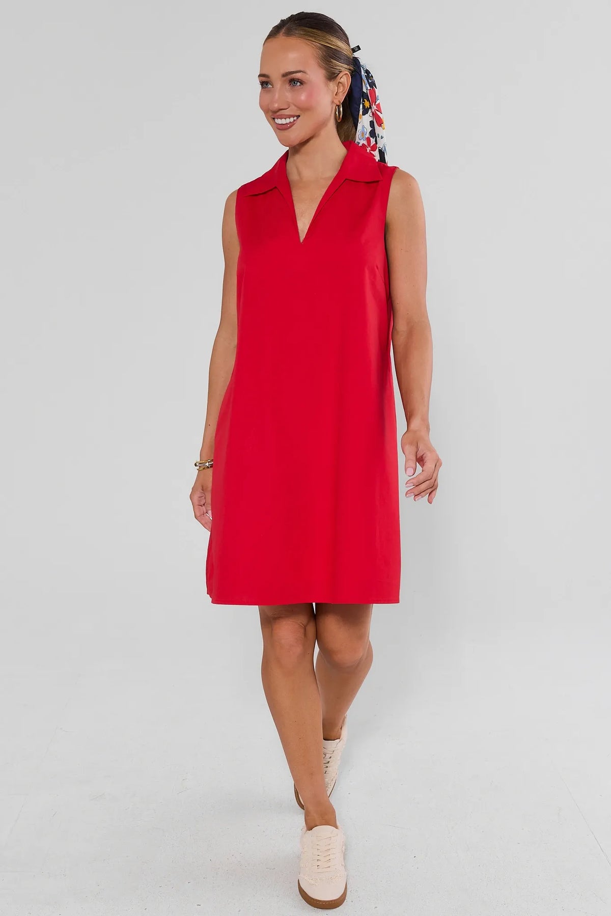 Woman walking in red Ellen Short Dress styled with floral scarf and sneakers - Styled Look | Avara