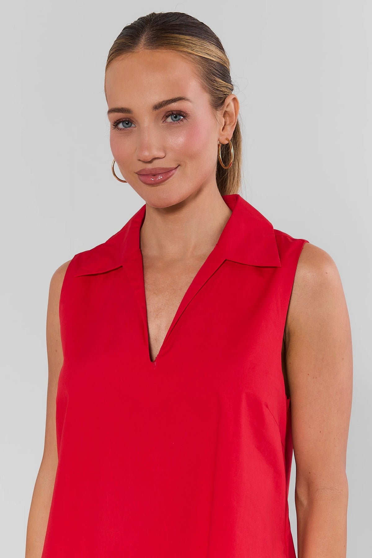 Close-up of red Ellen Short Dress collared V-neckline detail on model - Neckline Detail | Avara