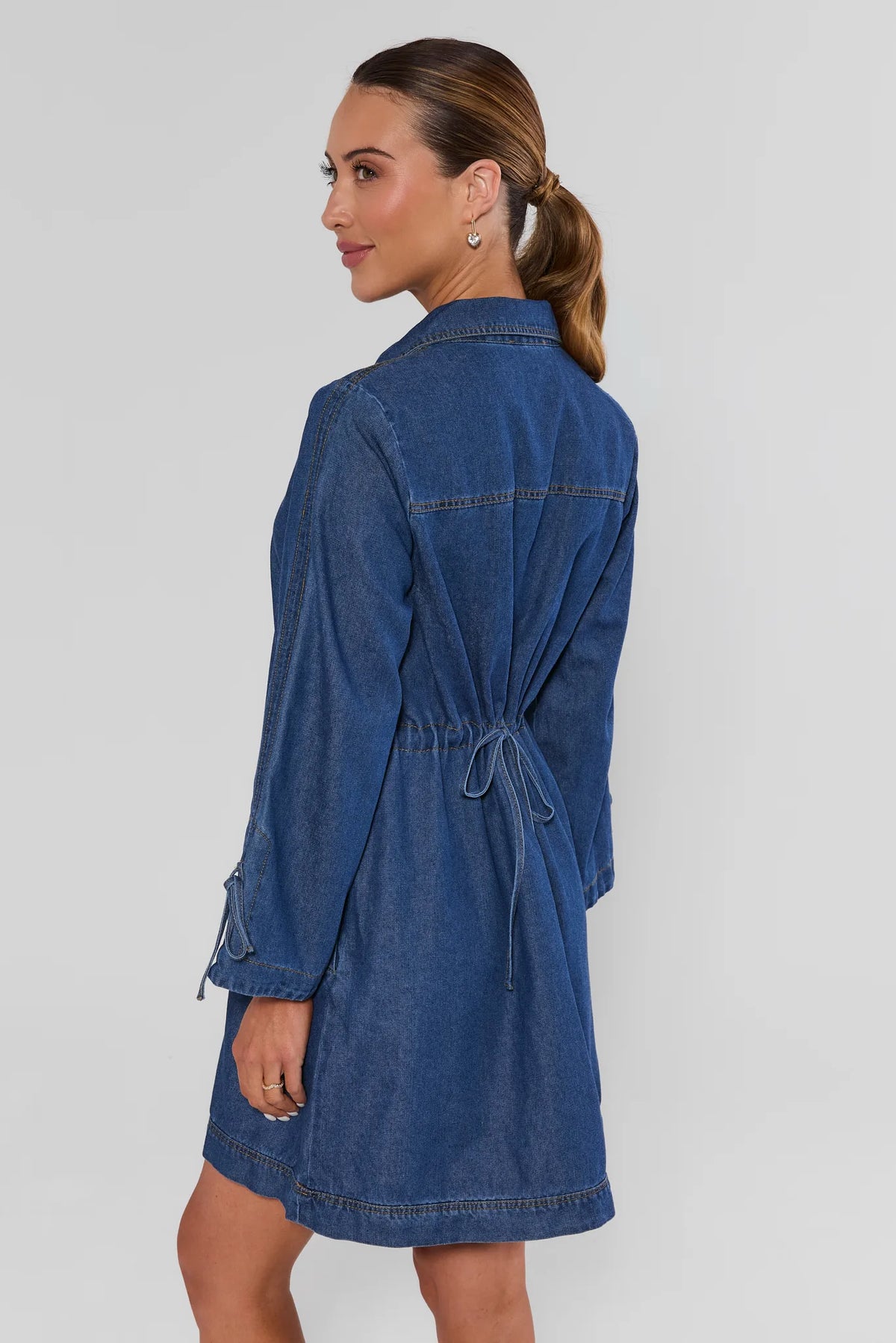 Shay Denim Mini Dress back view showing drawstring waist tie detail in medium blue wash - Back View | Avara