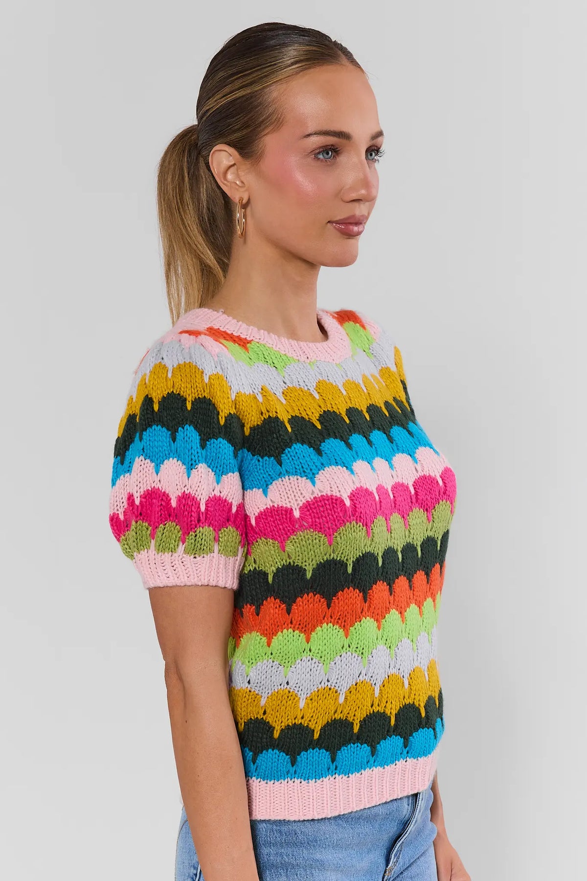 Woman wearing Trina Multi Striped Knit Top with jeans - Side View, short-sleeve colorful striped knit top for women | Avara