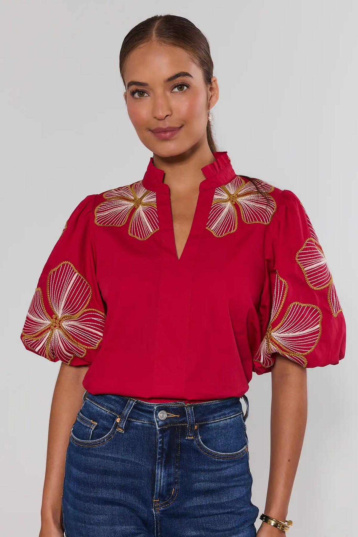 Red floral embroidered puff sleeve top by THML with ruffle V-neckline, front view on model | Avara