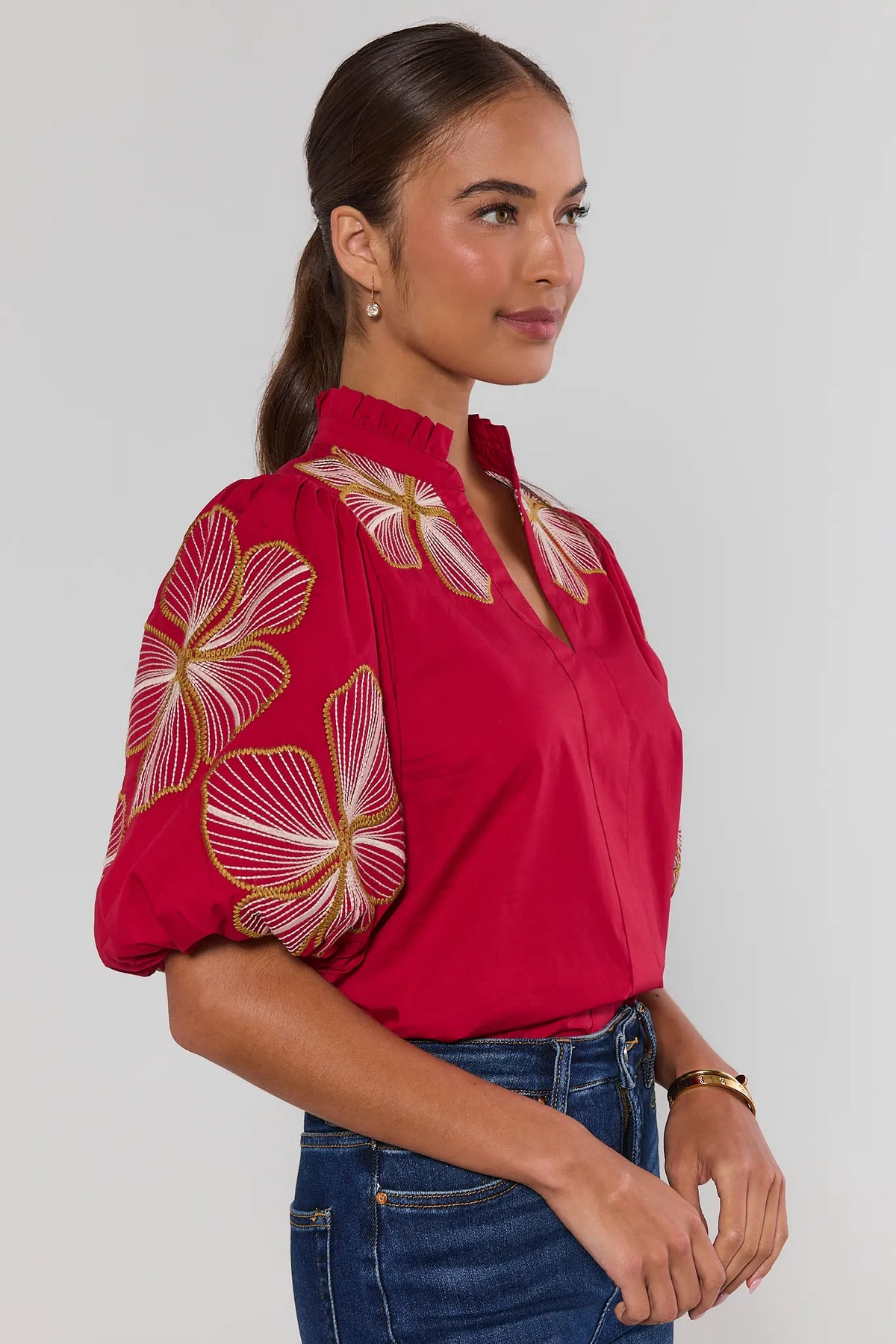 Red THML Harley embroidered puff sleeve top with ruffle collar, side profile view on model with jeans | Avara