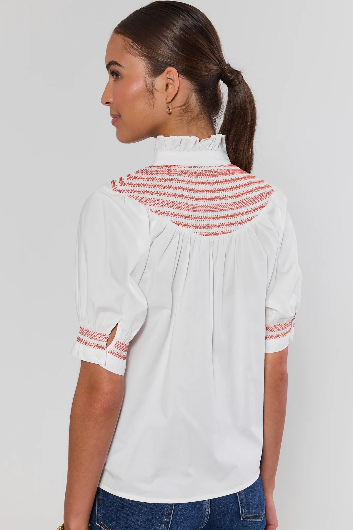 Yvonne White and Rust Embroidered Top showing rust smocked back yoke, ruffle collar, and embroidered cuffs - Back View | Avara