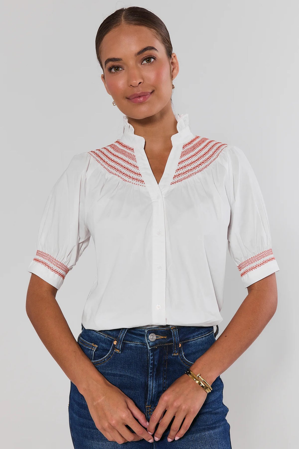 Yvonne White and Rust Embroidered Top with puff sleeves and button front, paired with denim jeans - Front View | Avara