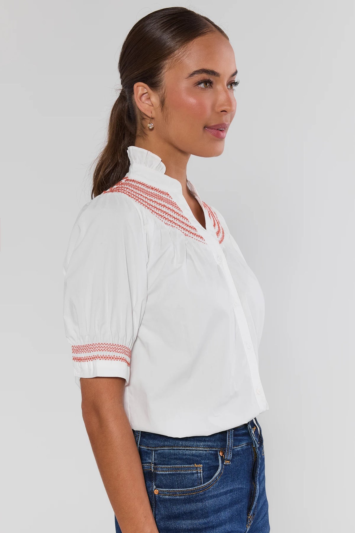 Yvonne White and Rust Embroidered Top with puff sleeves and rust embroidery, paired with denim jeans - Side View | Avara