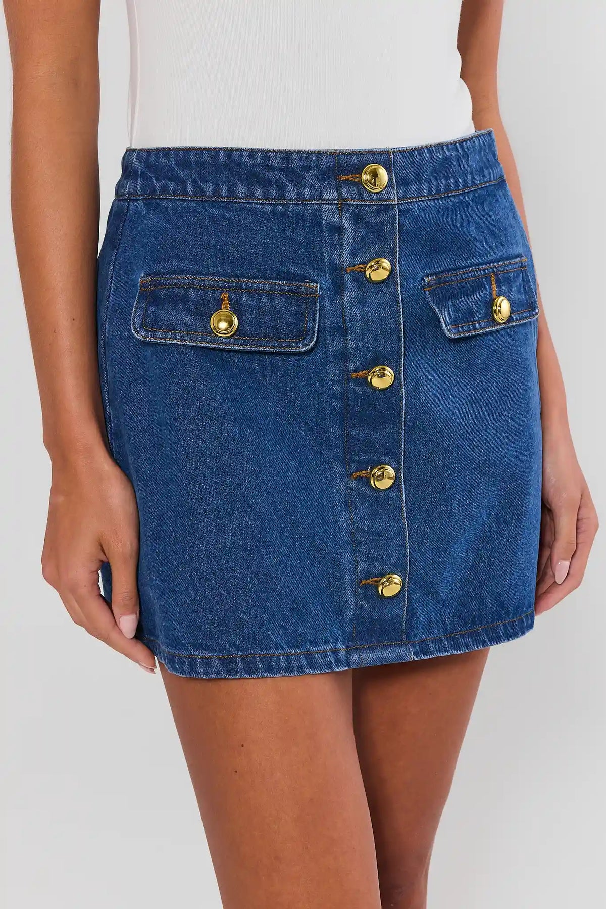 Close-up of Vickie Denim Button Up Skirt with gold-tone buttons and flap pockets - Front Detail | Avara