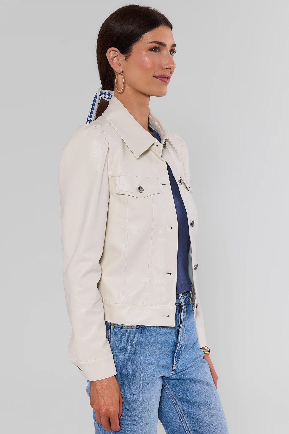 Roxanna Cream Faux Leather Jacket - Side Profile View, puff shoulder silhouette styled with blue jeans | Avara
