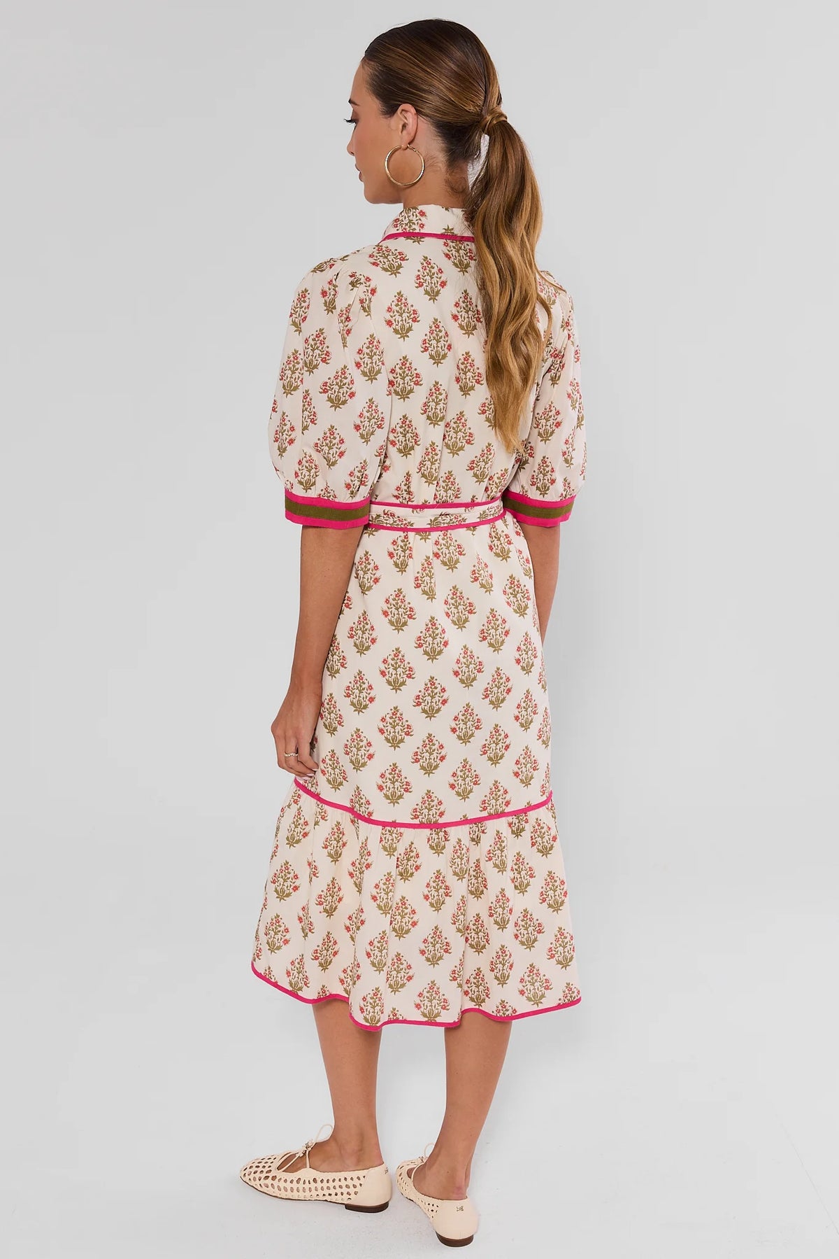 Woman wearing White Floral Button Up Midi Dress by THML - Back View, pink trim tiered hem modest floral midi dress | Avara