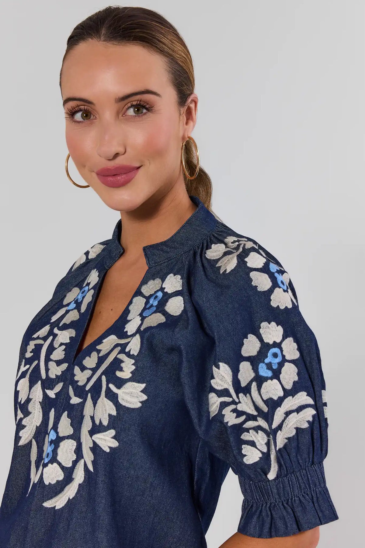 Close-up of Navy Floral Embroidered Top by THML - Embroidery & Smocked Sleeve Detail | Avara