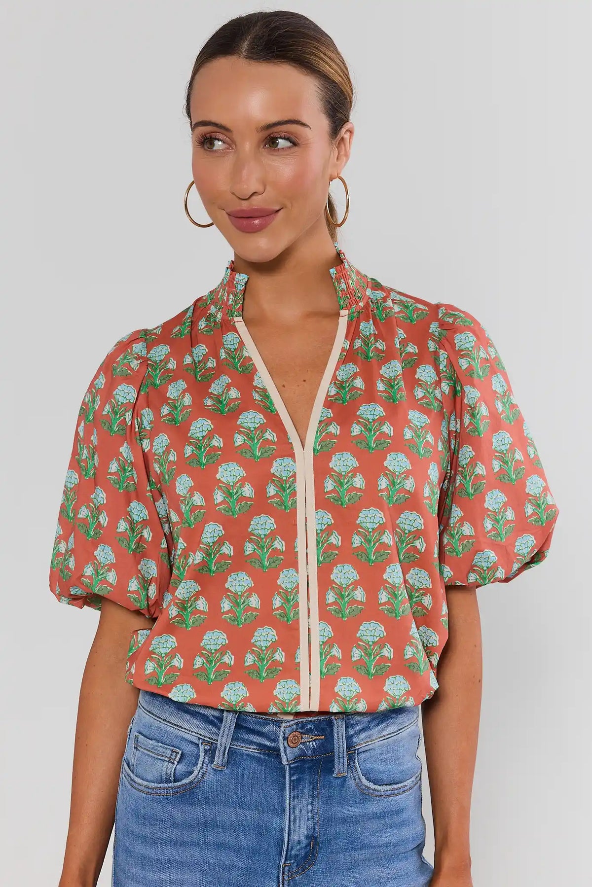 Orange floral printed top by THML with puffed short sleeves, smocked neckline, cream split front - Front View | Avara
