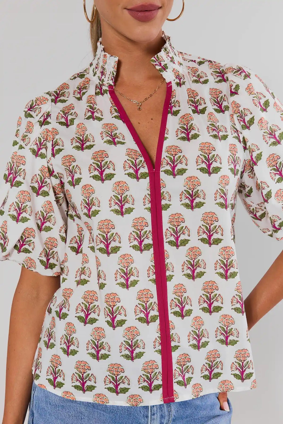 Close-up front detail of White Floral Printed Top by THML showing smocked neckline, block print, and magenta zipper trim | Avara