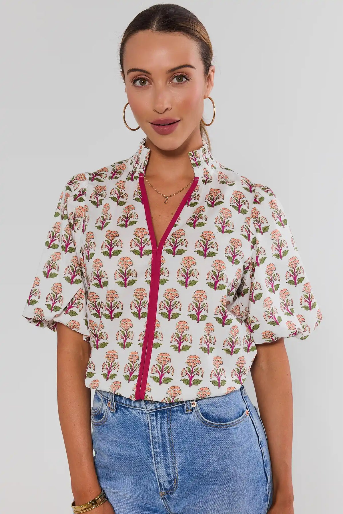 White Floral Printed Top by THML with puff sleeves and magenta zipper, styled with blue jeans - Front View | Avara