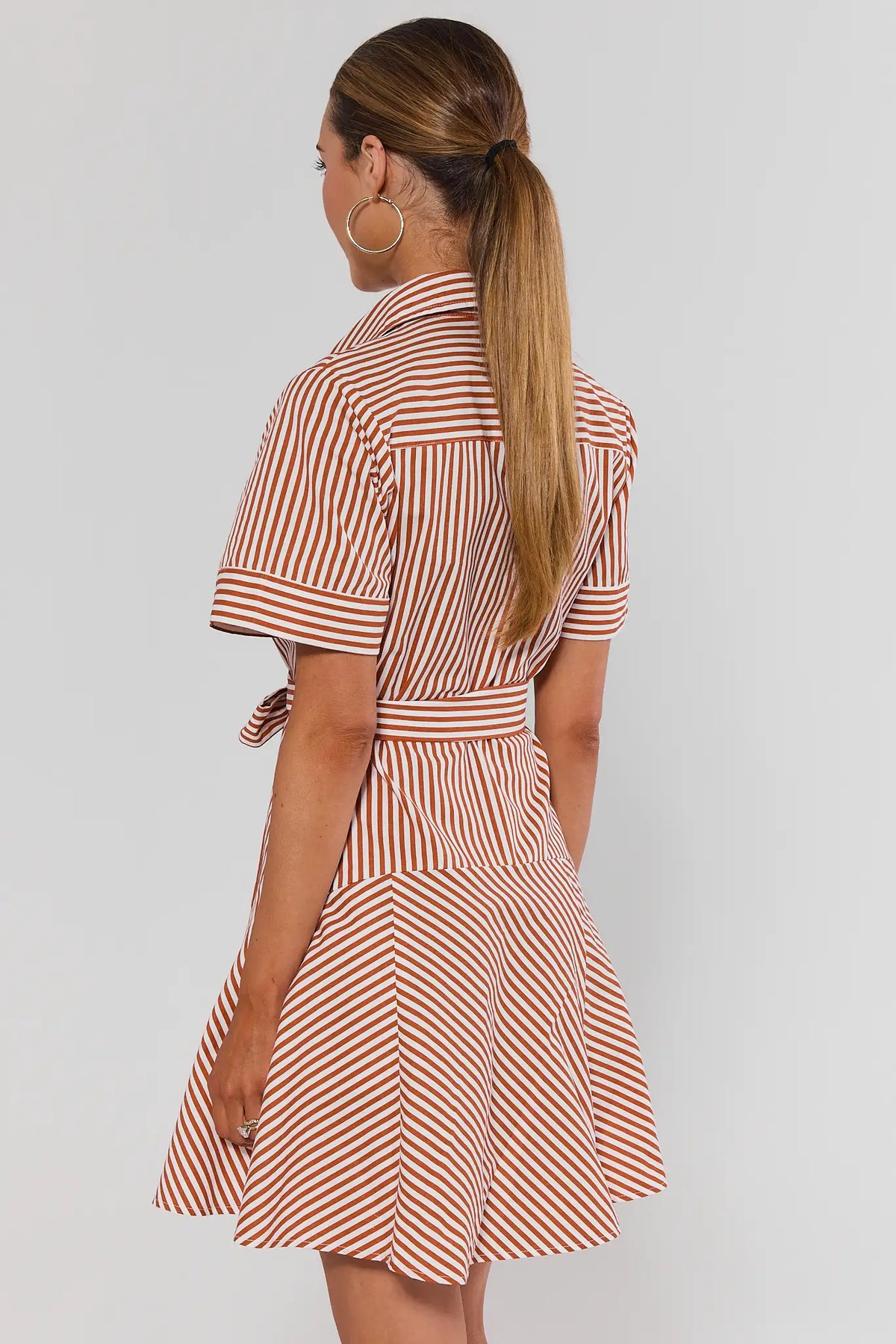 Millie Rust Striped Short Dress back view showing flared skirt, tie waist, and short cuffed sleeves | Avara